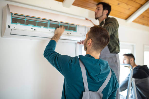 Ac technician in dubai checking ac
